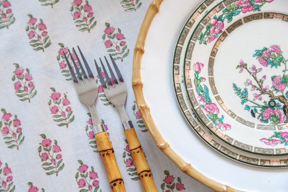 Pink and green block printed round tablecloth with china plate