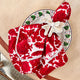 Red block printed napkin with napkin ring on table