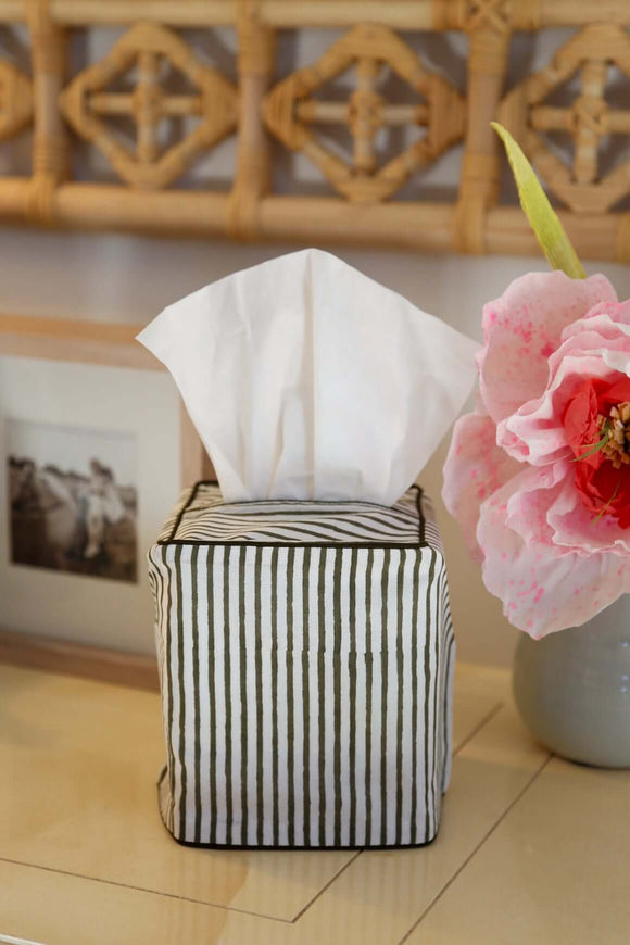 Green and white striped block printed tissue box cover on table