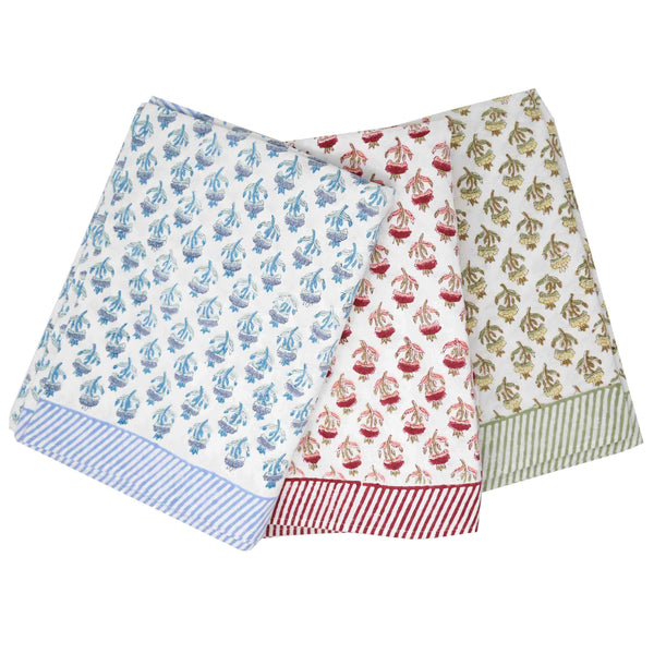 Trio of block printed floral tablecloths in blue, red, and green