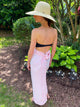Girl in garden wearing pink block printed cover up