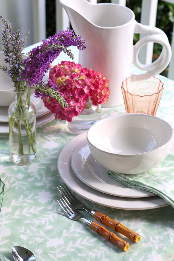 Camellia Tablecloth | Our Camellia print is a crowd-pleasing, grounded base upon which you can build any table scheme. With a calming ocean blue background and contrasting pale blue outlines, this tangle of vines adds sophistication and season-less warmth