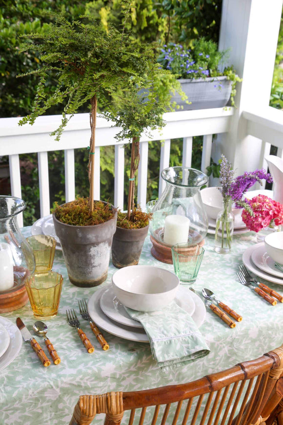 Camellia Tablecloth | Our Camellia print is a crowd-pleasing, grounded base upon which you can build any table scheme. With a calming ocean blue background and contrasting pale blue outlines, this tangle of vines adds sophistication and season-less warmth