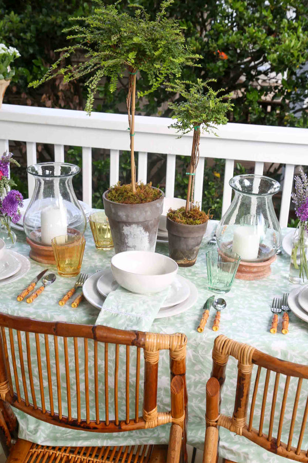 Camellia Tablecloth | Our Camellia print is a crowd-pleasing, grounded base upon which you can build any table scheme. With a calming ocean blue background and contrasting pale blue outlines, this tangle of vines adds sophistication and season-less warmth