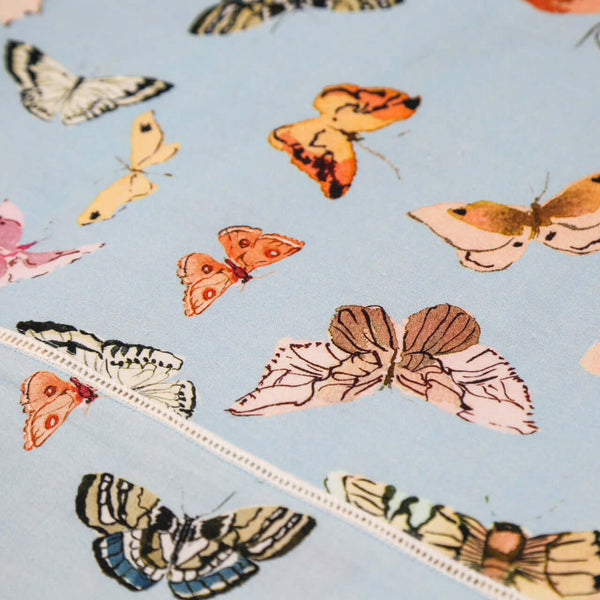 Inslee Persephone Linen Tablecloth | The Persephone linen block print tablecloth features Inslee Fariss’s watercolor butterflies on soft blue—elegant, airy, and perfect for relaxed gatherings.