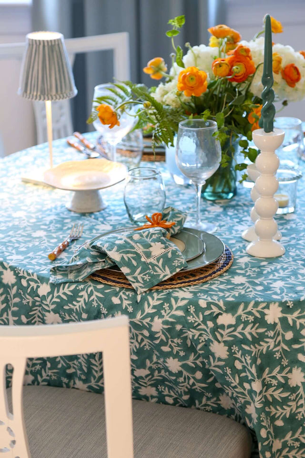 Camellia Tablecloth | Our Camellia print is a crowd-pleasing, grounded base upon which you can build any table scheme. With a calming ocean blue background and contrasting pale blue outlines, this tangle of vines adds sophistication and season-less warmth