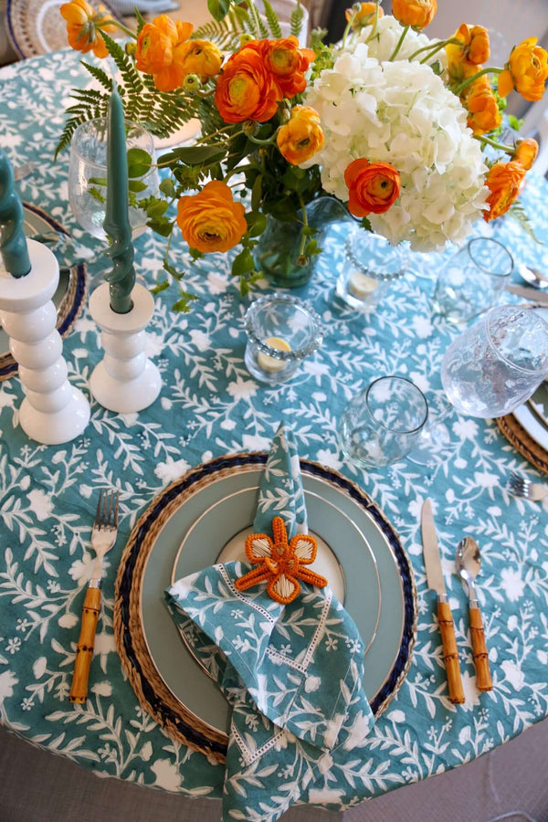 Camellia Tablecloth | Our Camellia print is a crowd-pleasing, grounded base upon which you can build any table scheme. With a calming ocean blue background and contrasting pale blue outlines, this tangle of vines adds sophistication and season-less warmth