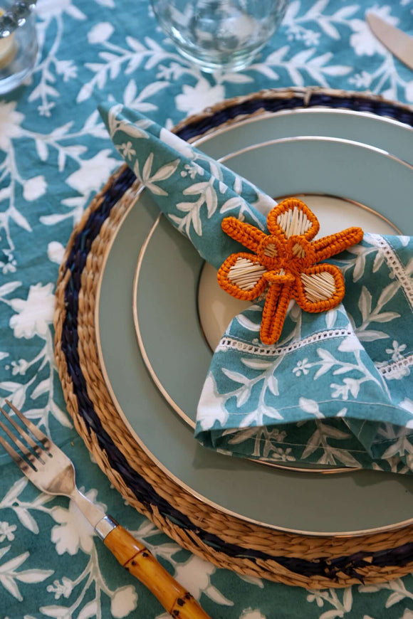 Camellia Napkins, Set of 4 | Our Camellia print is a crowd-pleasing, grounded base upon which you can build any table scheme. With a calming ocean blue background and contrasting pale blue outlines, this tangle of vines adds sophistication and seasonless