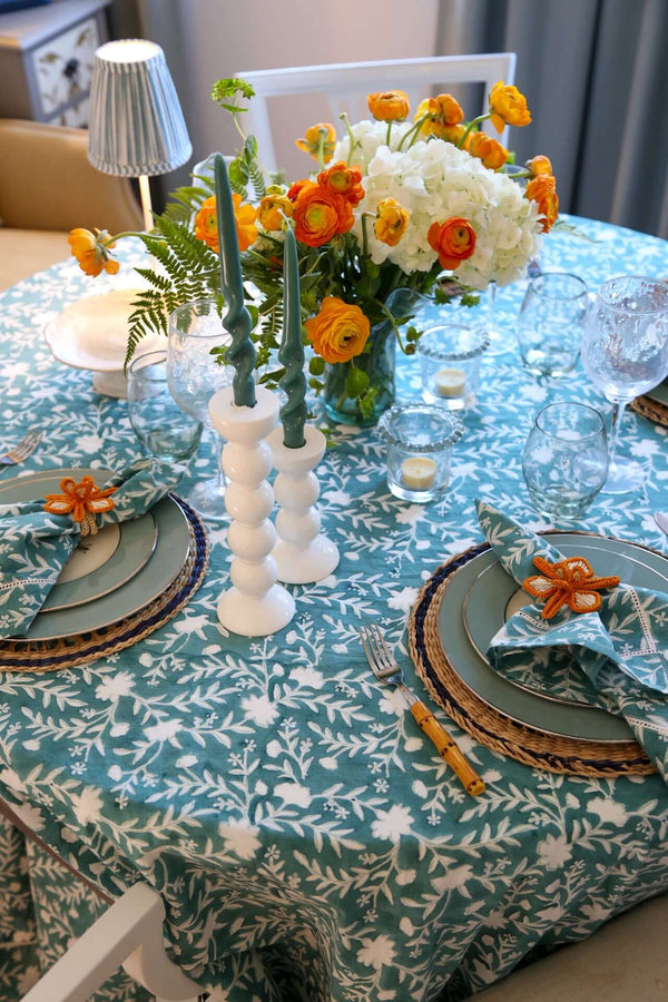 Camellia Tablecloth | Our Camellia print is a crowd-pleasing, grounded base upon which you can build any table scheme. With a calming ocean blue background and contrasting pale blue outlines, this tangle of vines adds sophistication and season-less warmth