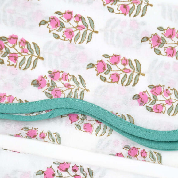 pink and white block printed napkin with green piping