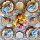 Overhead of dining table set with blue linen cloth napkins