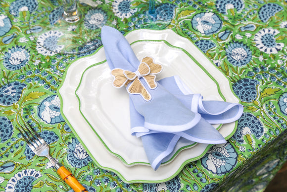 Blue napkin on melamine plates and green block printed tablecloth