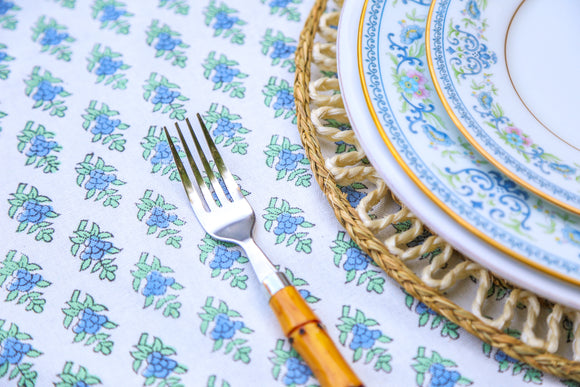 Plate setting on blue and white floral block printed rectangular tablecloth