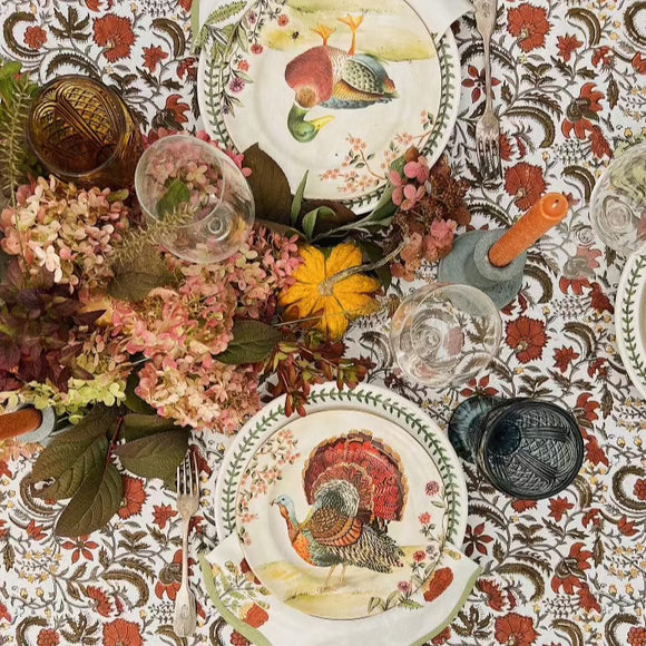 Fall table setting with block printed tablecloth, flowers and plates