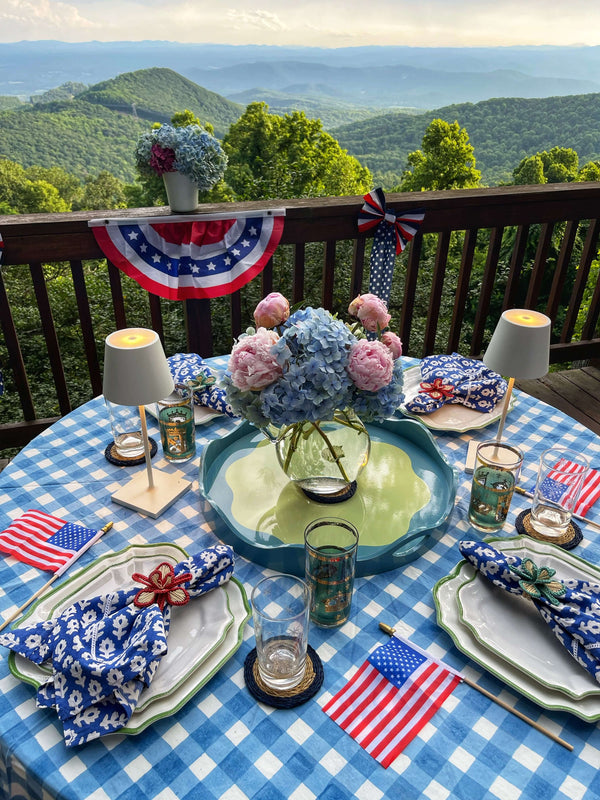 Table set with blue gingham tablecloth with small American flags
