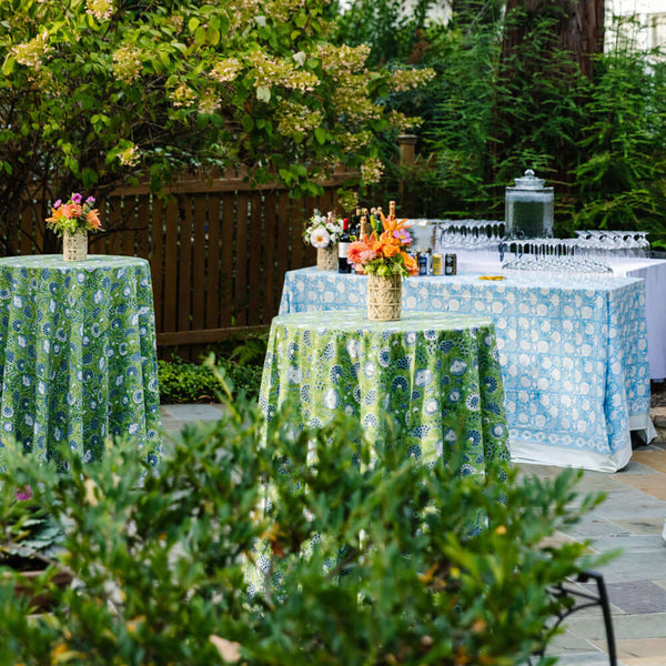 Banquet tables with green and blue block printed tablecloths