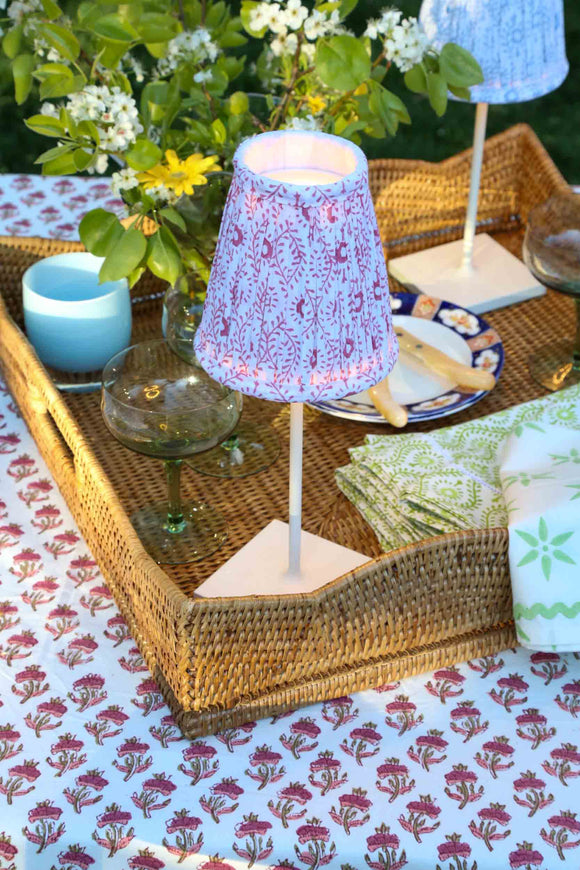 Red block printed lampshade on Poldina Pro cordless lamp in wicker tray