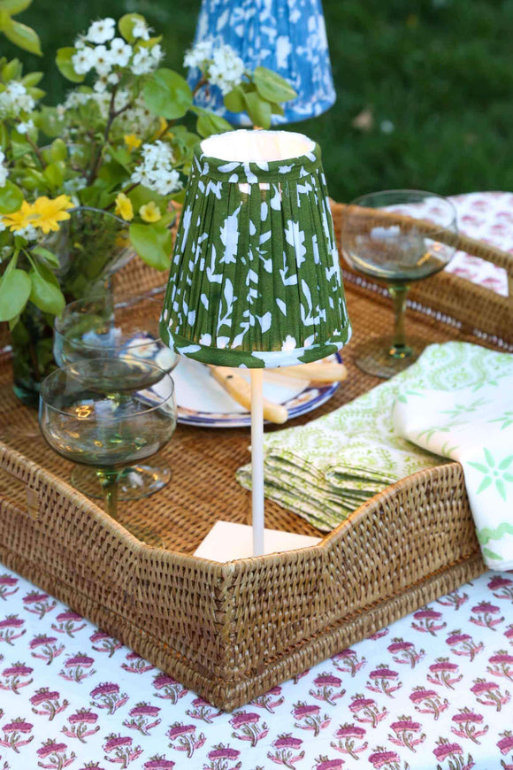 Blue and green block printed lampshades on cordless lamps in a wicker tray