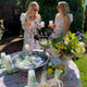 Two girls at outdoor cocktail by refreshment table
