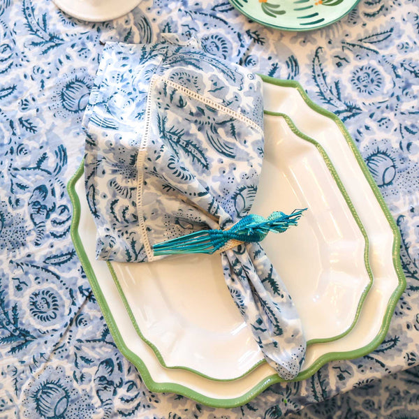 Blue block printed napkin on plate with blue tablecloth