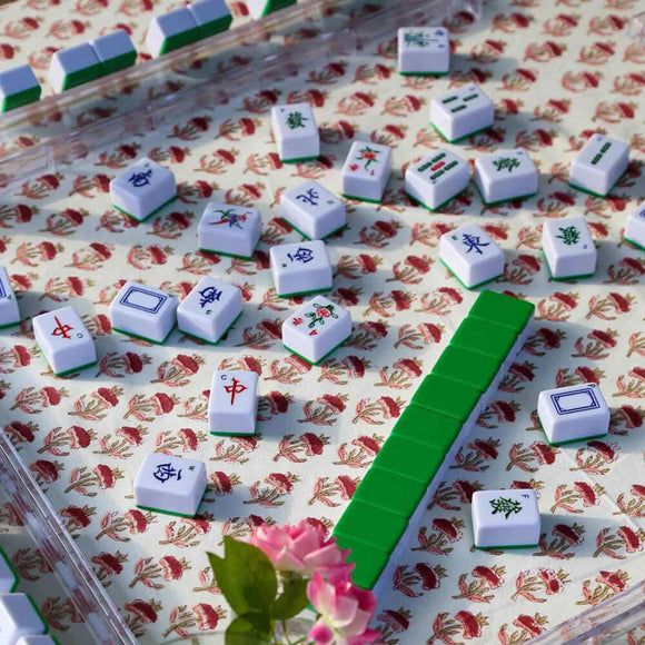 Mahjong set on red block printed floral tablecloth