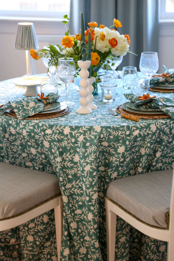 Camellia Tablecloth | Our Camellia print is a crowd-pleasing, grounded base upon which you can build any table scheme. With a calming ocean blue background and contrasting pale blue outlines, this tangle of vines adds sophistication and season-less warmth