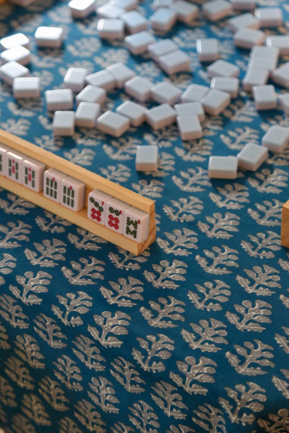 Mahjong set on blue block printed tablecloth