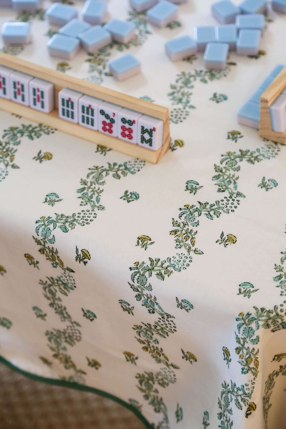 Mahjong set on green and white block printed tablecloth