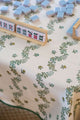 Mahjong set on green and white block printed tablecloth