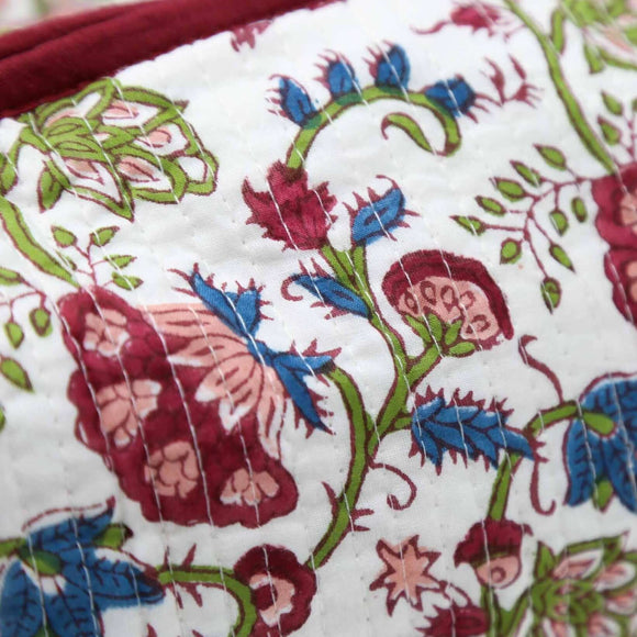 Close up of white and red block printed toiletry bag