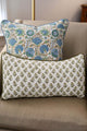 Two block printed pillows resting on chair