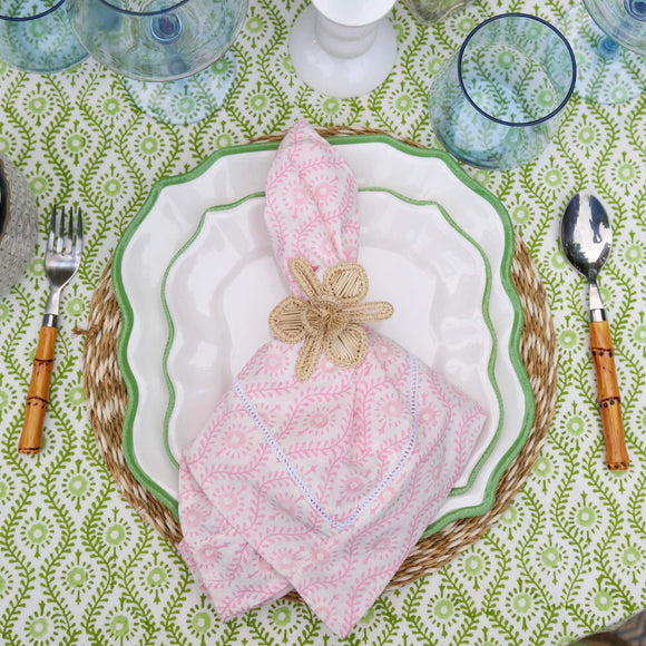 Pink block printed napkin on green tablecloth