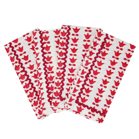 Four red and white block printed napkins with red tulip flower pattern