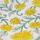 Close up of yellow floral block printed napkin fabric