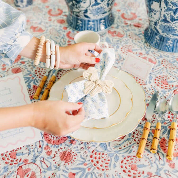Setting a table with a blue napkin with napkin ring