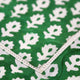 Close up of hemstitch on green block printed napkin