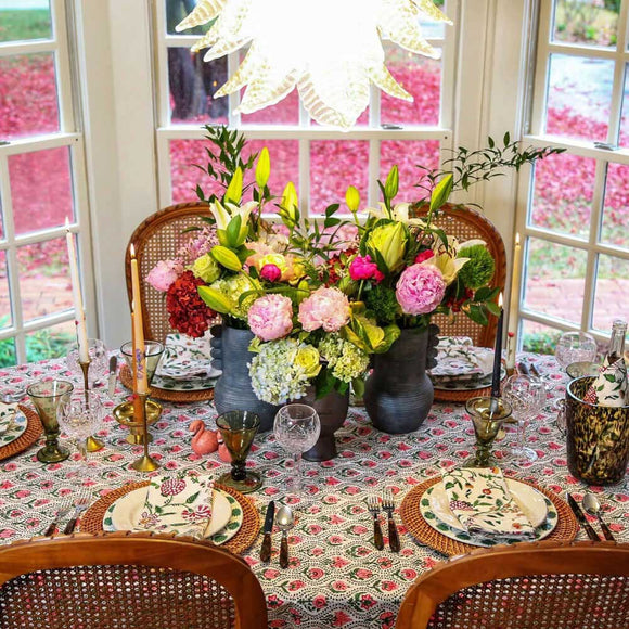 Floral tablecloth table set with large bouquet centerpiece of flowers
