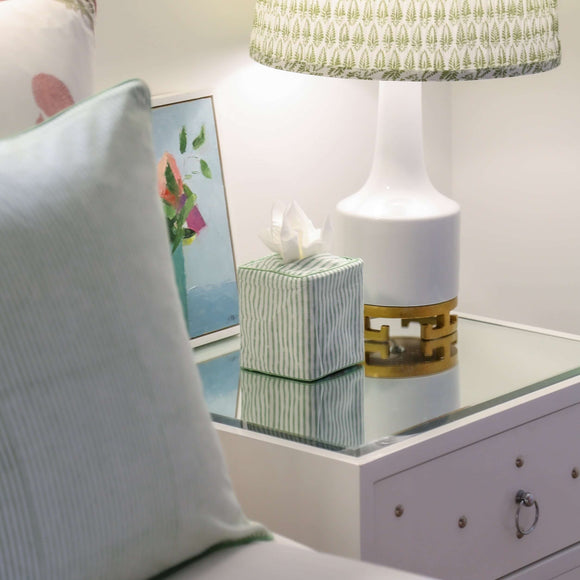 Striped block printed tissue box cover on bedside table