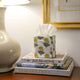 Yellow and green floral tissue box cover on books