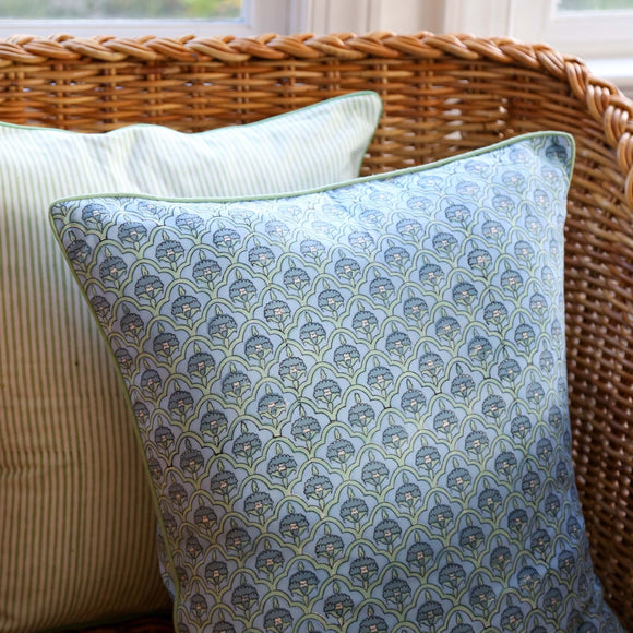 Two block printed pillows on wicker chair