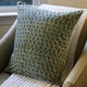 Green block printed pillow cover on chair