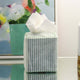 Blue striped block printed tissue box cover on bedside table