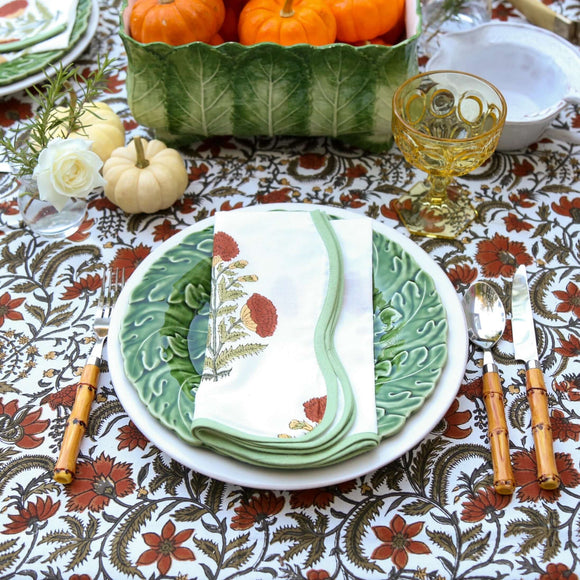 Block printed napkin on green plate with fall decor