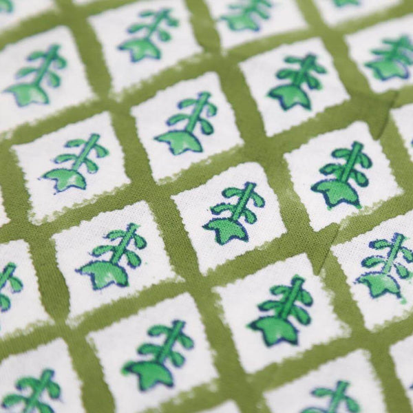 Close up of green floral block printed tablecloth fabric
